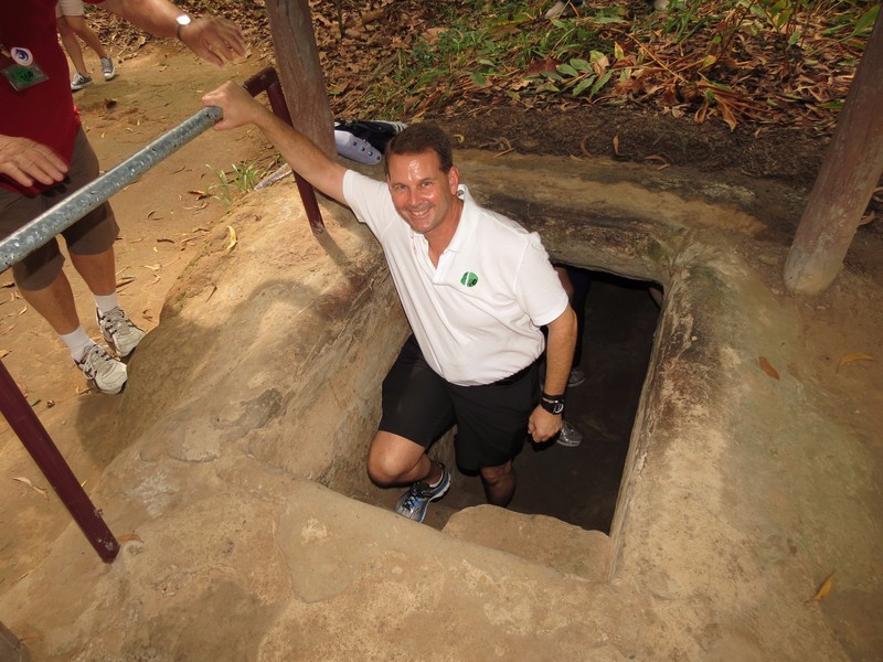Todd entering one of the Củ Chi tunnels
