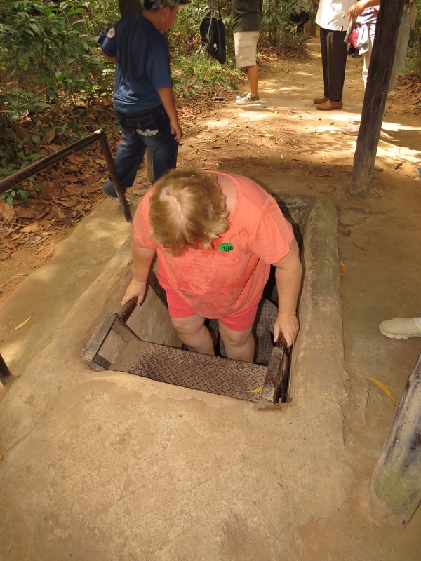Cindy exiting one of the Củ Chi tunnels