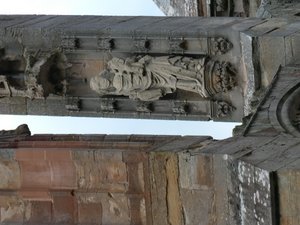 Old statue of Mary and Child defaced over time by weather