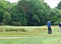 Group in front playing first hole on Walton Heath open course
