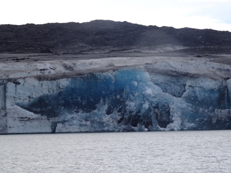 glacier face showing deep blue older ice