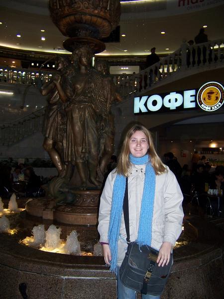 Next to the statue in the mall