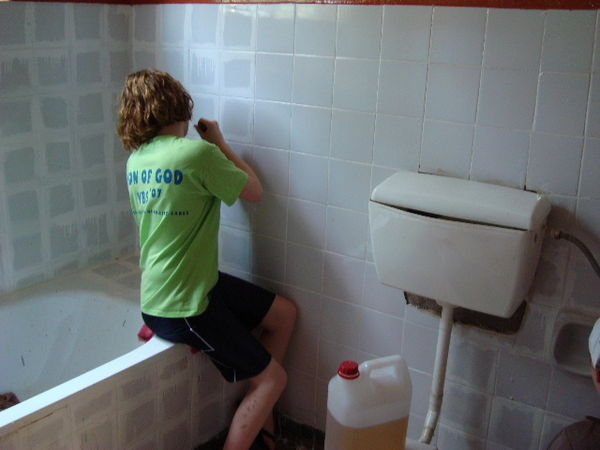 Callie Helping to scrape the bath room walls...