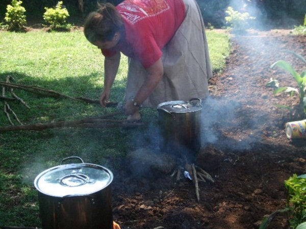 Julie cooking beans and rice in the yard