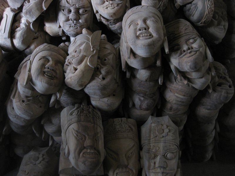 Stacks of carved masks. 