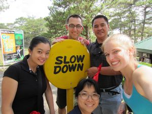 'Picture in front of a "slow down" sign'