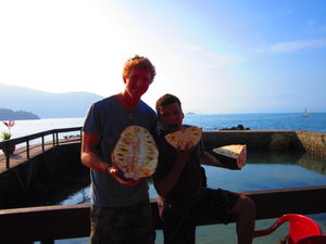 Ben with the hostel guy and the weird fruit