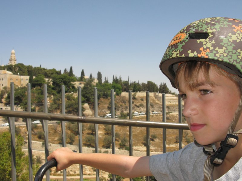 Adin contemplates joining Israeli army. Mount Zion in background