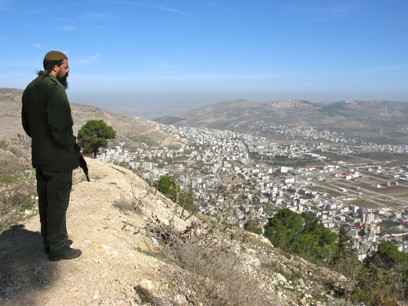 Our armed escort looks down from Mount Gerezim onto Nablus