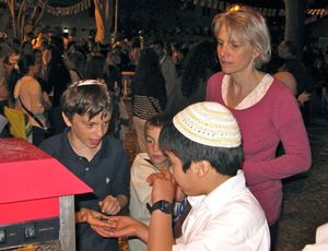 Ezra negotiates purchase of cotton candy in Jewish Quarter