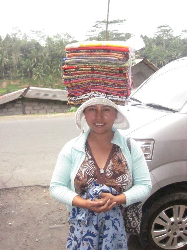 Bali girl carrying her goods