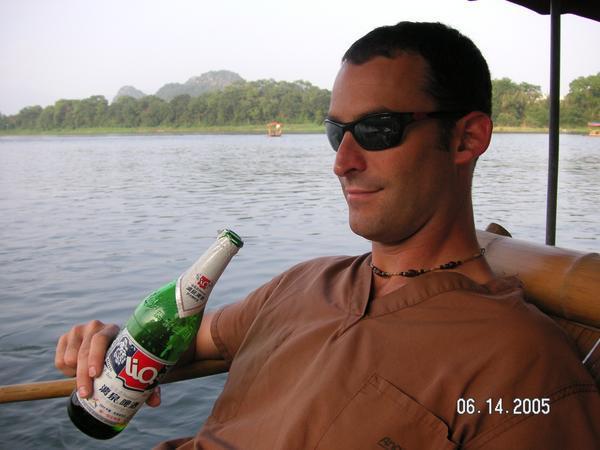 Enjoying local beverage on our bamboo raft