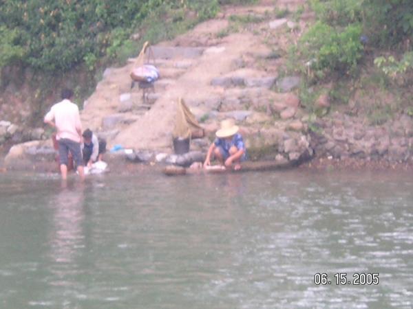 Locals wash clothes in the River