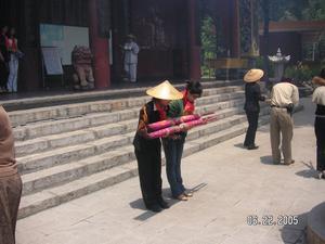 A visitor participates in tradition of lighting large inscent at the temple