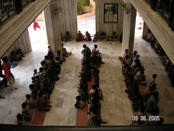 Members of Krishna sit and pray