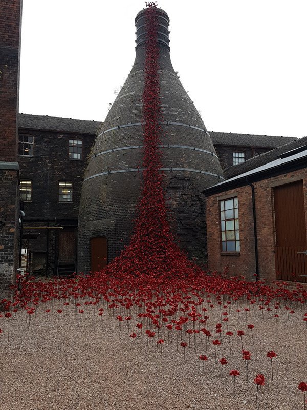 A cascade of blood red ceramic poppies