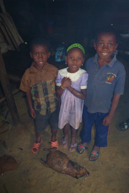 Kids with a marmota, cane rat, in Engong Aconibe