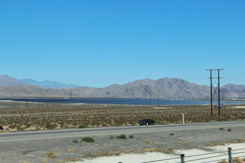 a field of solar panels, looks like a lake