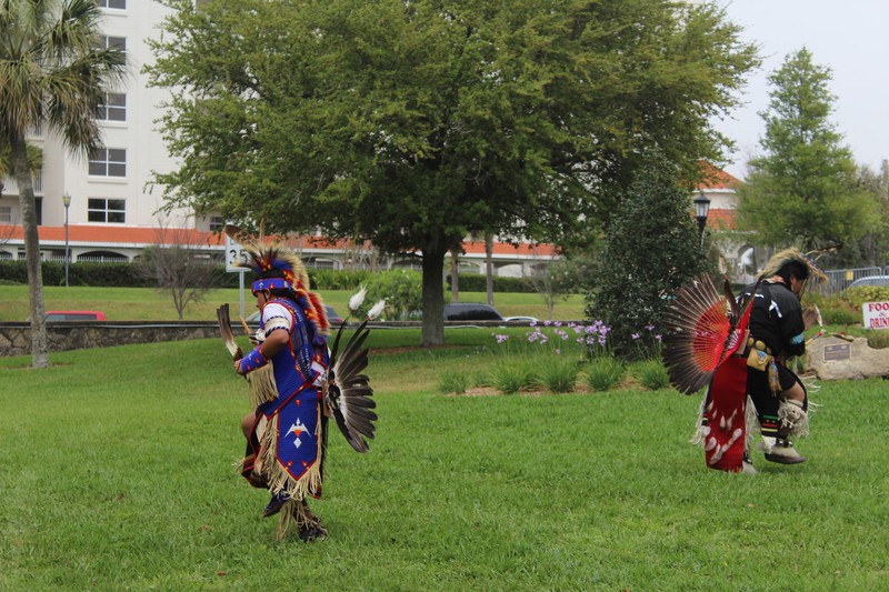 2 native dancers doing the grass stomping dance