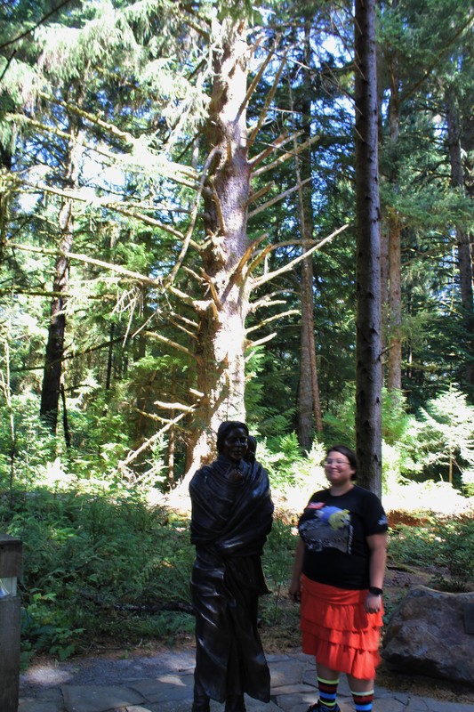 Megan with a statue of Sacajawea/ 100 year old Sitka spruce in the background 