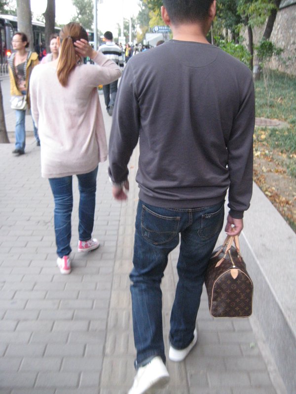 Guys always carry their girlfriend's purse