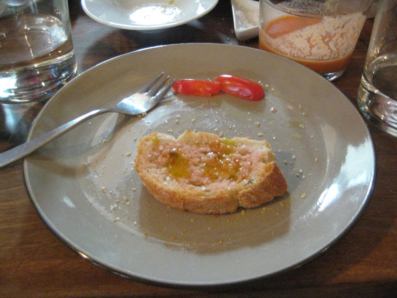 Squeeze the juice from cherry tomato onto bread and add olive oil