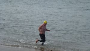Crazy running man in a swimming cap!