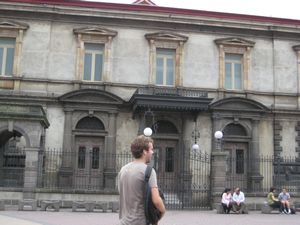 Drew laughing in front of an old, cool building