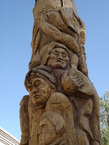 wooden sculpture of indigenous struggle