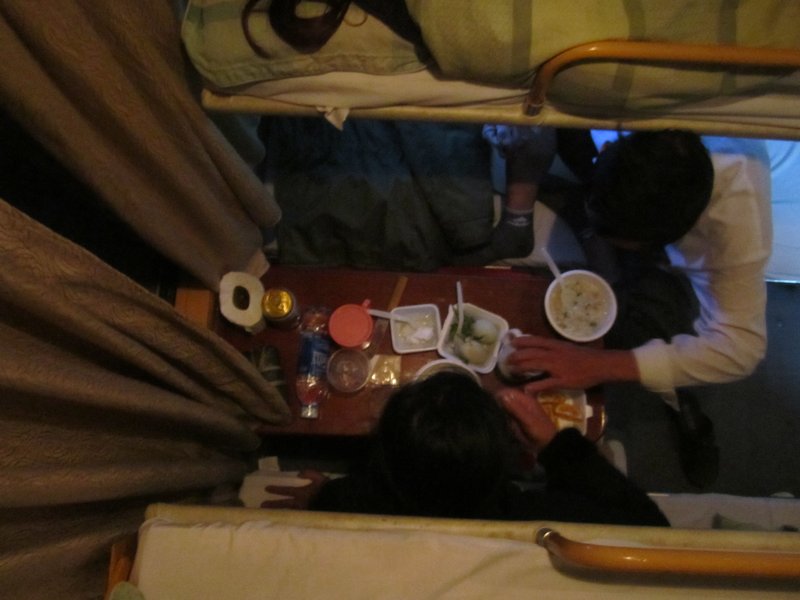 The drunk couple enjoying their train food of noodle soup and duck eggs