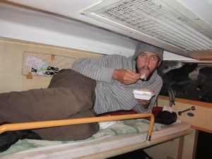 Terry enjoying train food on the top bunk of the train