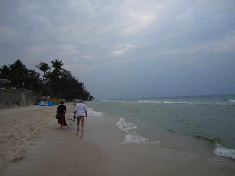 Terrys uncle and partner walking down the beach at Hua Hin