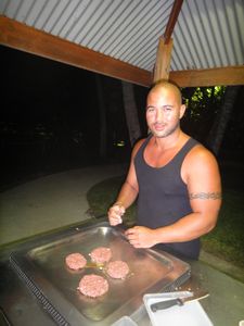 Anton cooking burgers on public BBQ at Port Douglas