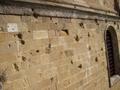 damage from WWII on the facade of the cathedral in Pienza..