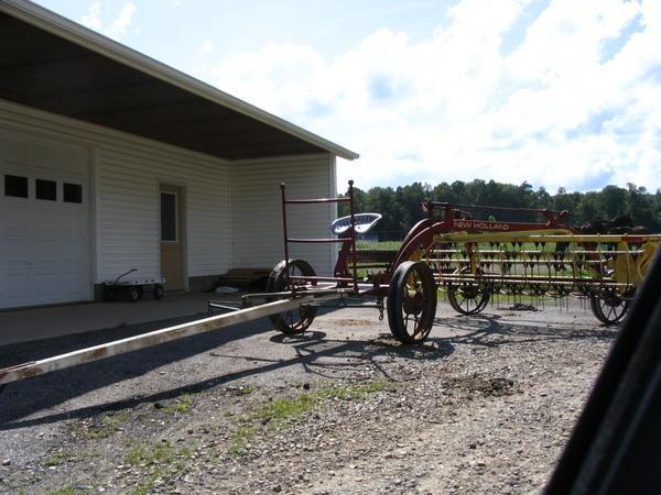 A horse-drawn side delivery hay rake