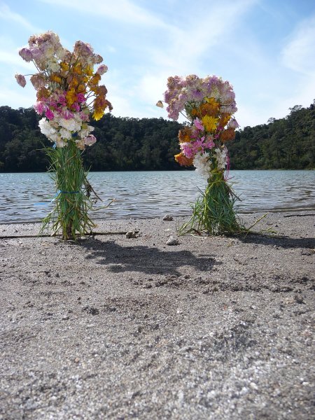 Flowers mark the site of sacrifice in the sacred lake