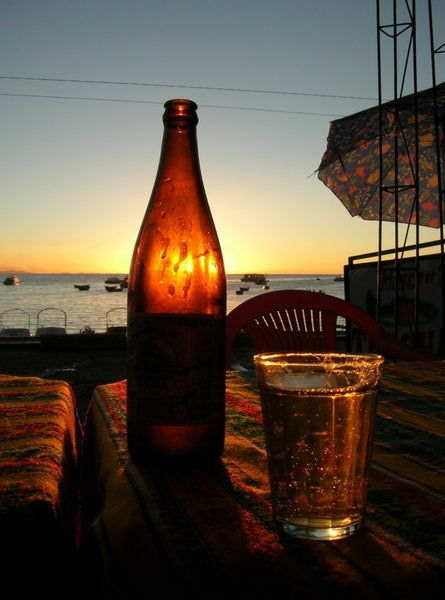 A beer as sunsets over lake Titicaca