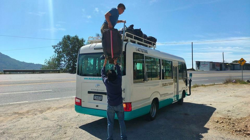 Loading out bags onto a minibus