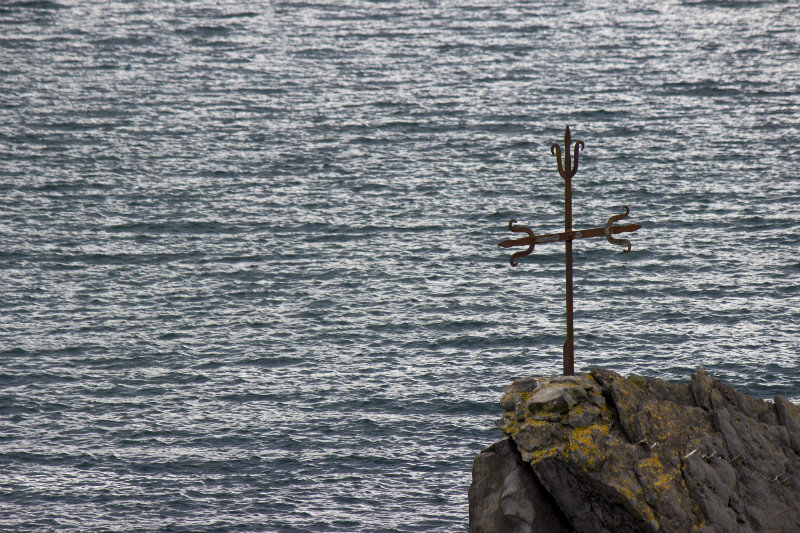 A cross looks lout to sea