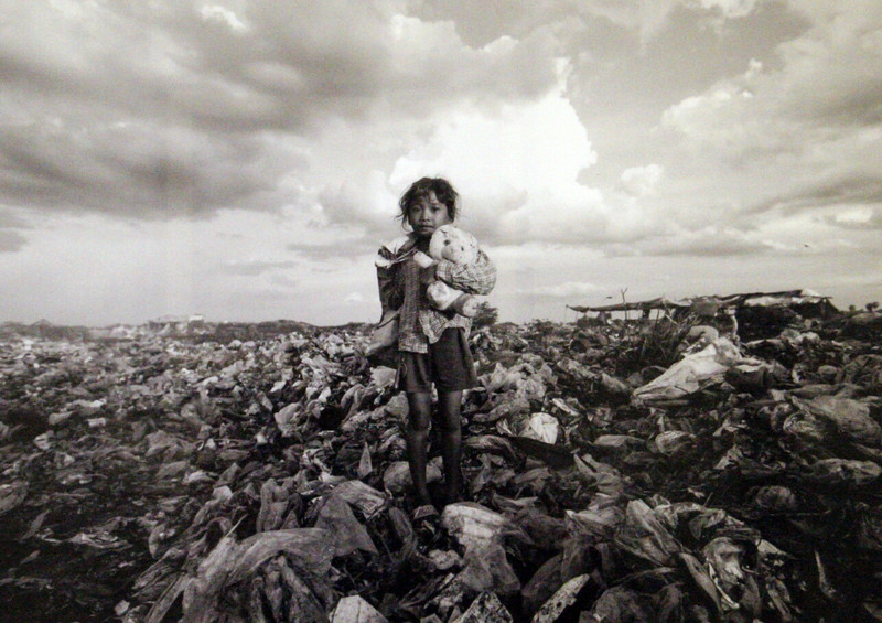 Girl on a rubbish dump