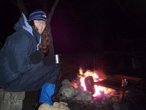 Keeping warm with a cuppa around the campfire