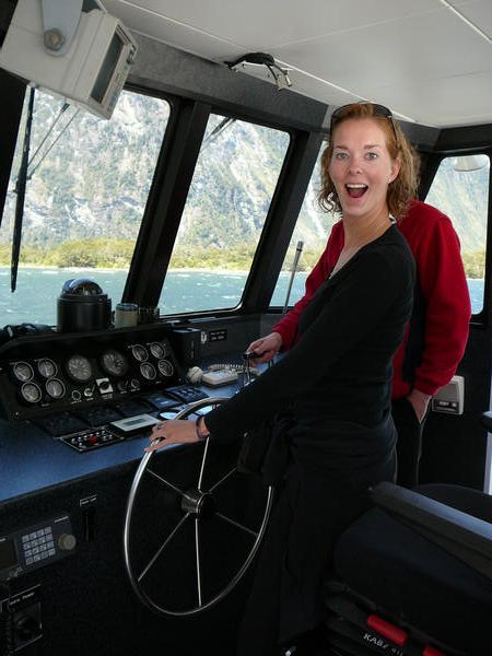 Becky assumes control of the boat in Milford Sound