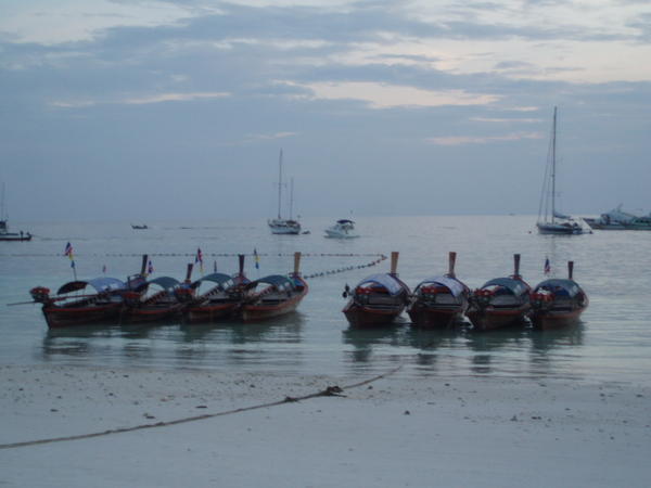 Boats on the beach at dusk