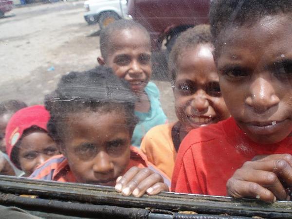 Children trying to catch a glimpse of us through the minibus window!