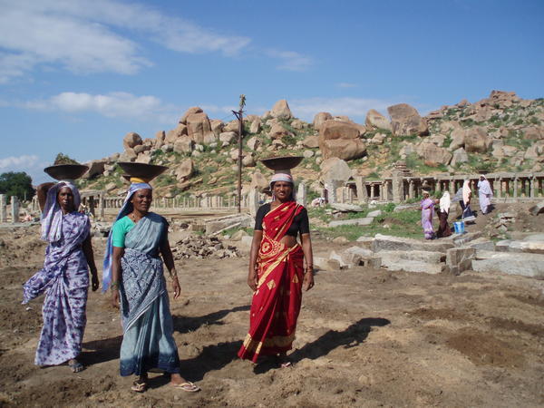 Local women carrying building materials to a ruin restoration site