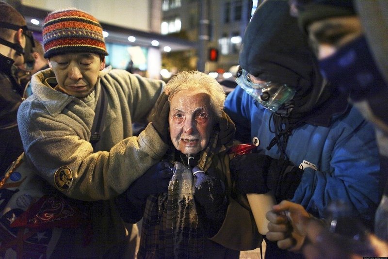 84-year-old Dorli Rainey was pepper sprayed during a peaceful march in Seattle, Washington. She would have been thrown to the ground and trampled, but luckily a fellow protester and Iraq vet was there to save her. (Joshua Trujillo / seattlepi.com)