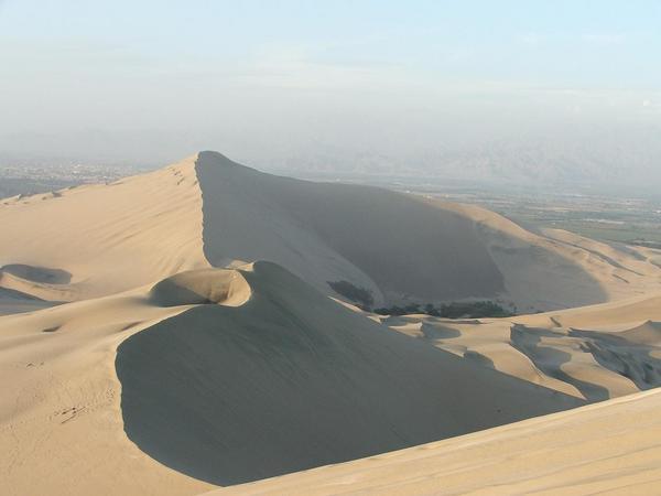 Huacachina surrounded by dunes.
