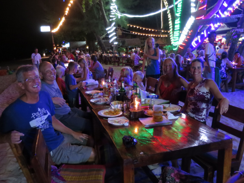 Three families dining out at Thaicat restaurant on the beach