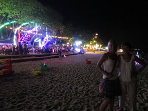 The beach is lit up at night making a colourful spectacle.