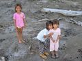 Children playing in the muddy lake